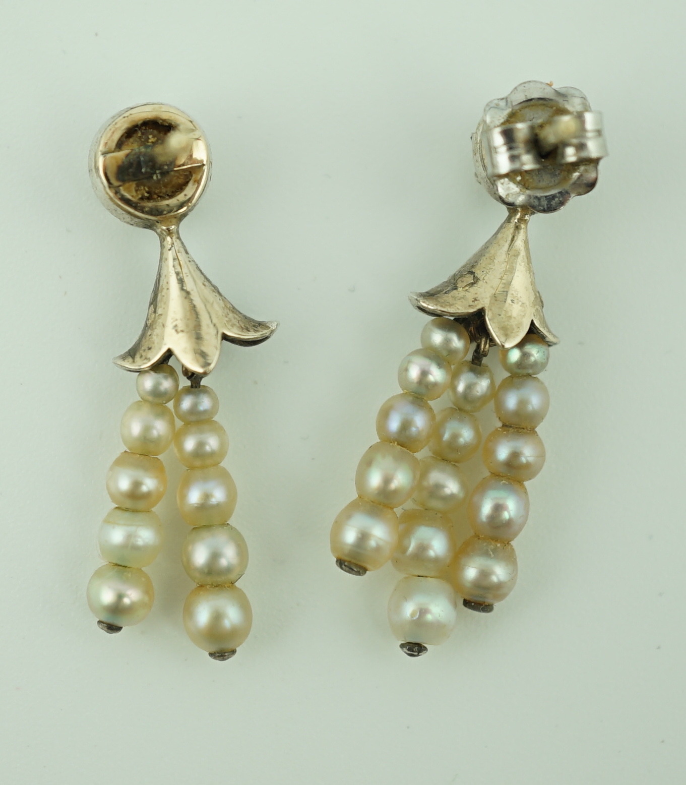 A pair of antique gold, graduated seed pearl, cushion and rose cut diamond set tassel drop earrings